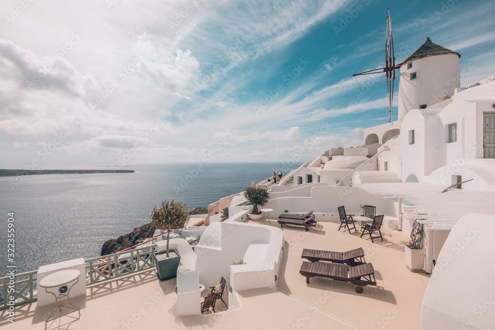 Fototapeta premium Famous travel destination, dramatic urban view, cloudy sky over beautiful architecture. Beautiful architecture in island Santorini, Greece