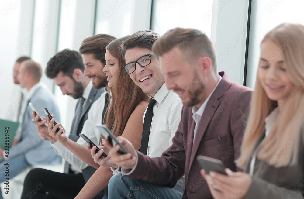 group of diverse young people sitting in the office lobby group of diverse young people sitting in the office lobby