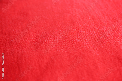 Red fabric texture, empty cotton cloth background. Soft textile material, close up top view of simple gradient t-shirt structure, fashion clothes elegant detail 