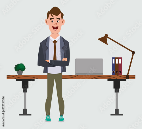 cute businessman stands near his table or workplace