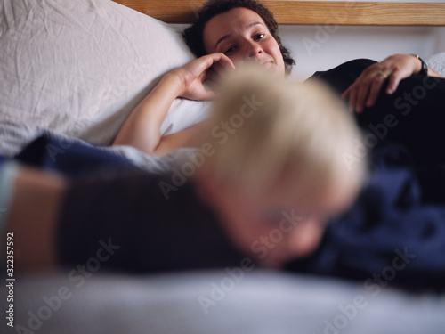 pregnant mum on bed with toddler  photo