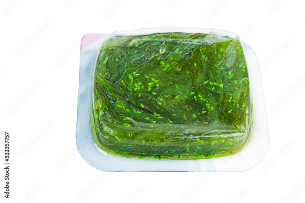 Wakame seaweed in plastic box isolated on white background Wakame seaweed in plastic box isolated on white background