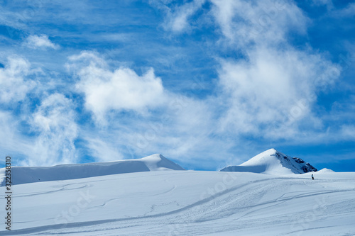 The image of snowboarders on a snowy mountain top. photo