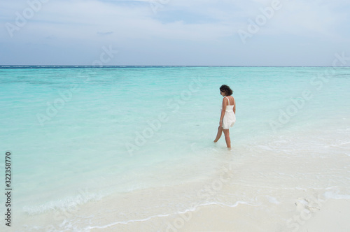 Woman walking on the beach © ilaDV