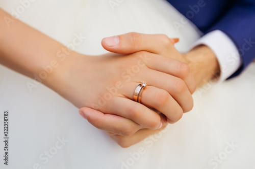 closeup of bride hand with wedding ring. the newlyweds are holdi