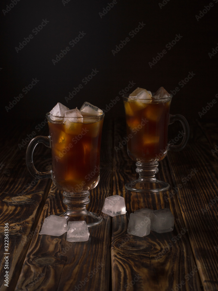 coffee drink with ice in a glass mug on a wooden background. coffee drink with ice in a glass mug on a wooden background.