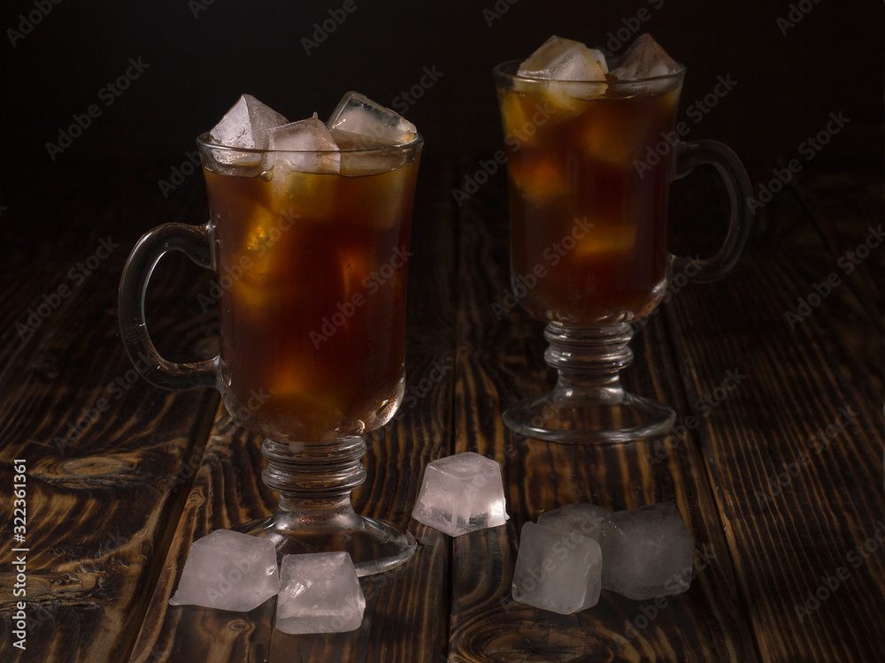 coffee drink with ice in a glass mug on a wooden background. coffee drink with ice in a glass mug on a wooden background.