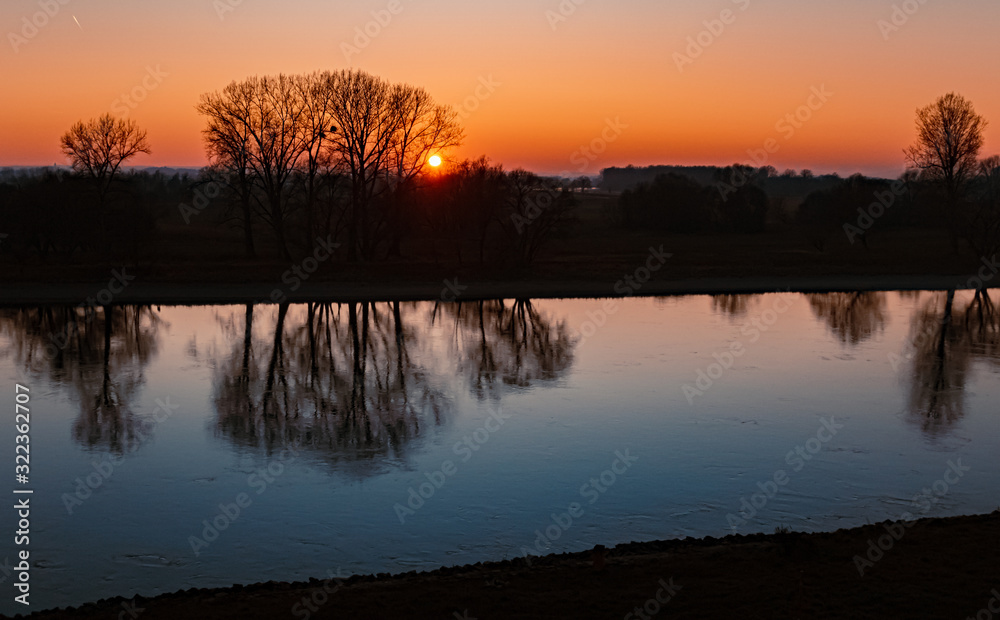 Beautiful sunset with reflections at the river danube near Winzer, Bavaria, Germany
