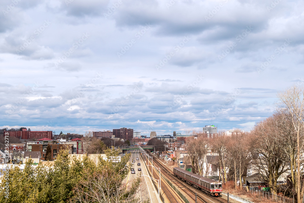 View of railway tracks, trains and downtown in the distance in Quincy, Massachusetts View of railway tracks, trains and downtown in the distance in Quincy, Massachusetts