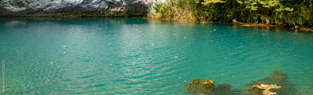 Unique blue mountain lake of the Caucasus located in a gorge with clear water and a depth of more than 100 meters