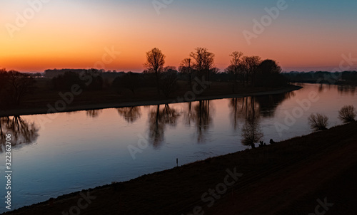 Beautiful sunset with reflections at the river danube near Winzer, Bavaria, Germany
