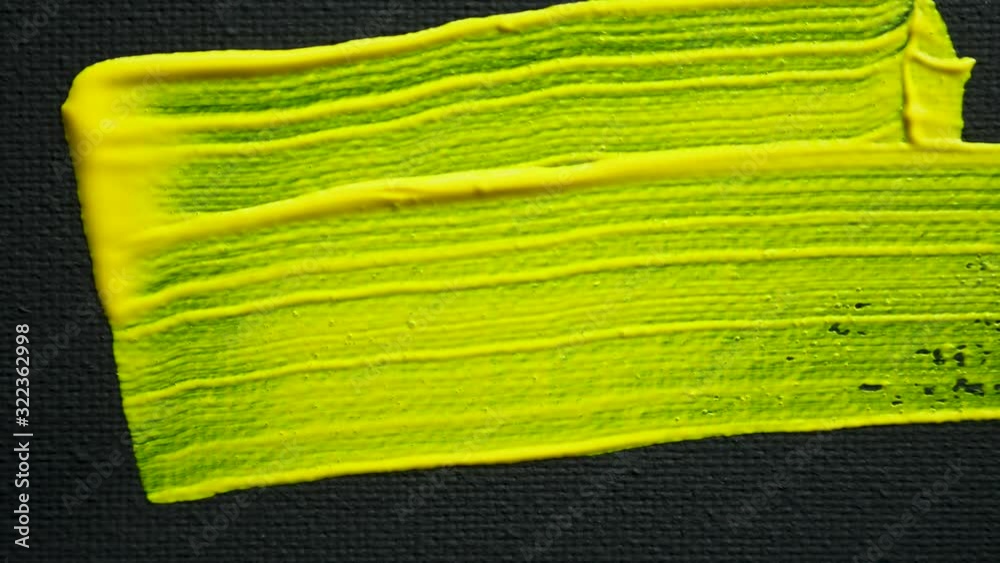 brush paints on black canvas with acrylic paint