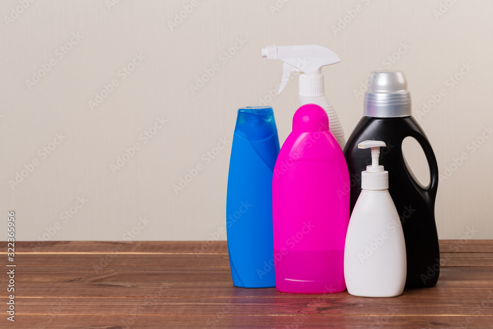 Cleaning product plastic container for house clean on wooden table and gray background . household chemicals Cleaning product plastic container for house clean on wooden table and gray background . household chemicals