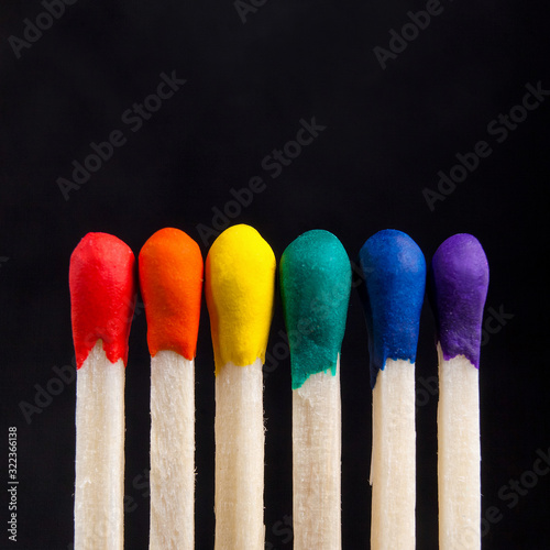 LGBT, protection of human rights concept. Multicolored matches in the colors of the flag of sexual minorities against the blank(dark) background. Diversity and Inclusion concept photo