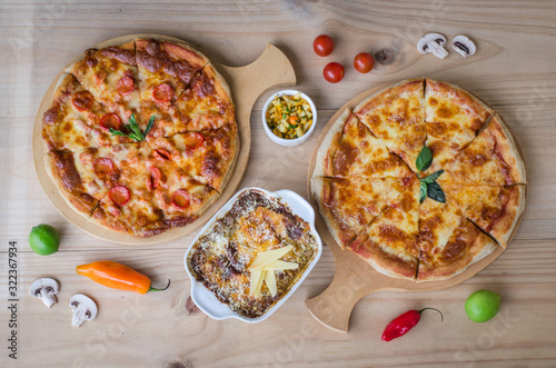Italian pizza and pasta served in the wooden table
