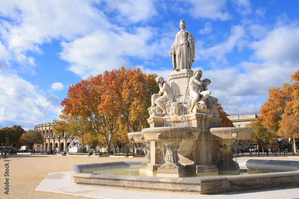 The amazing arena and Pradier fountain in Nimes, France The amazing arena and Pradier fountain in Nimes, France