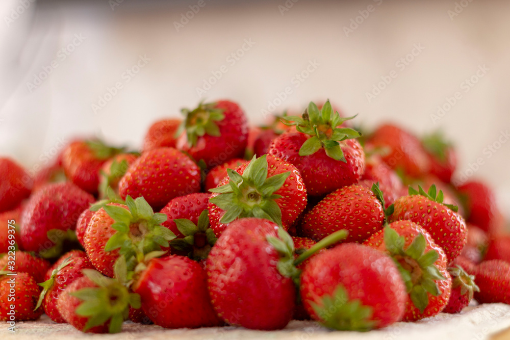 Lots of fresh ripe red strawberries on the white table. Home garden harvesting Lots of fresh ripe red strawberries on the white table. Home garden harvesting