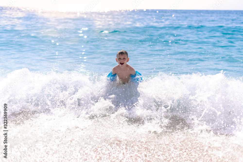 One boy is playing on the beach