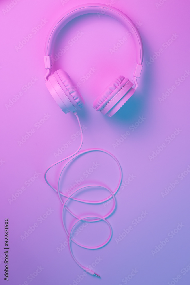Retro 90s style photo of white stylish wireless headphone in neon lights. Music concept. Retro 90s style photo of white stylish wireless headphone in neon lights. Music concept.