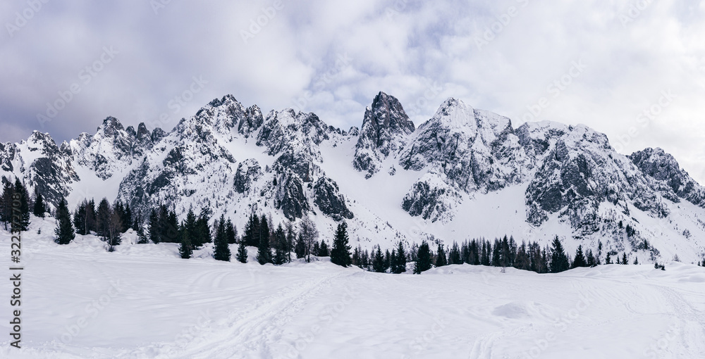 Panoramic view of the Scalve valley with its snowy peaks, near the town of Schilpario, Italy - January 2020.