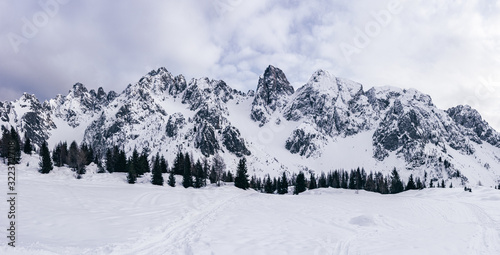 Panoramic view of the Scalve valley with its snowy peaks, near the town of Schilpario, Italy - January 2020.