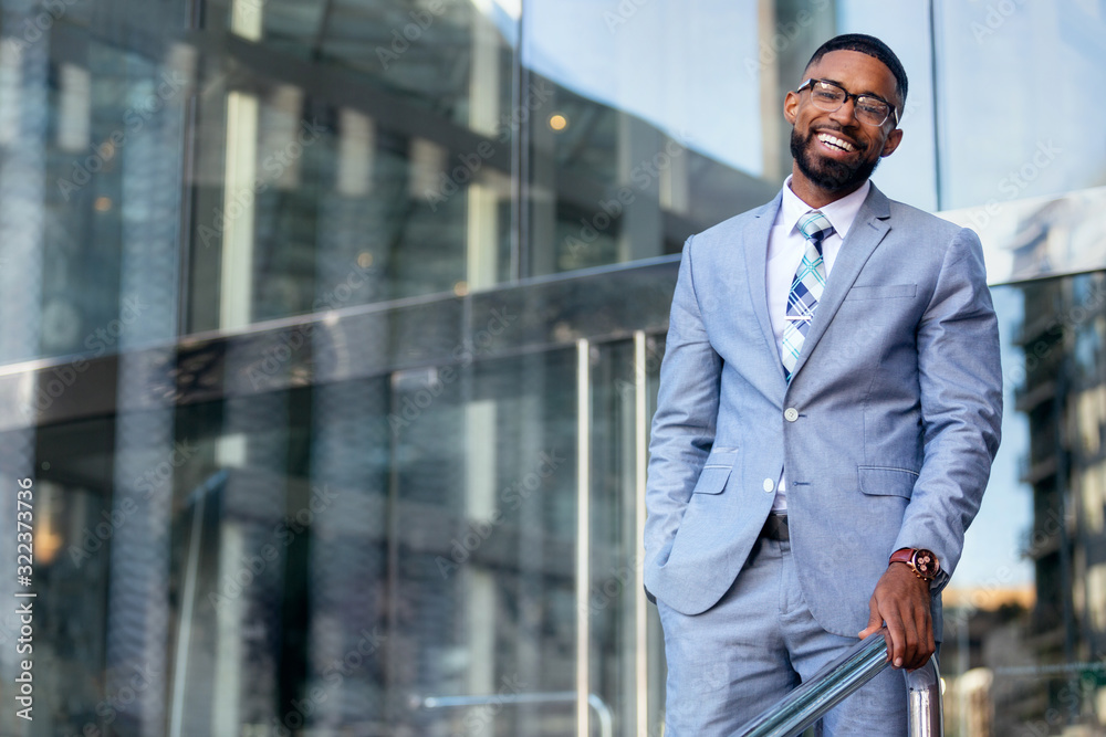 Smiling cheerful successful African American CEO businessman in stylish modern suit, happy warm distinguished portrait Smiling cheerful successful African American CEO businessman in stylish modern suit, happy warm distinguished portrait