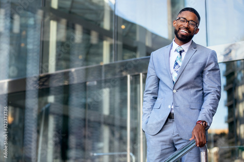 Fototapeta Smiling cheerful successful African American CEO businessman in stylish modern s