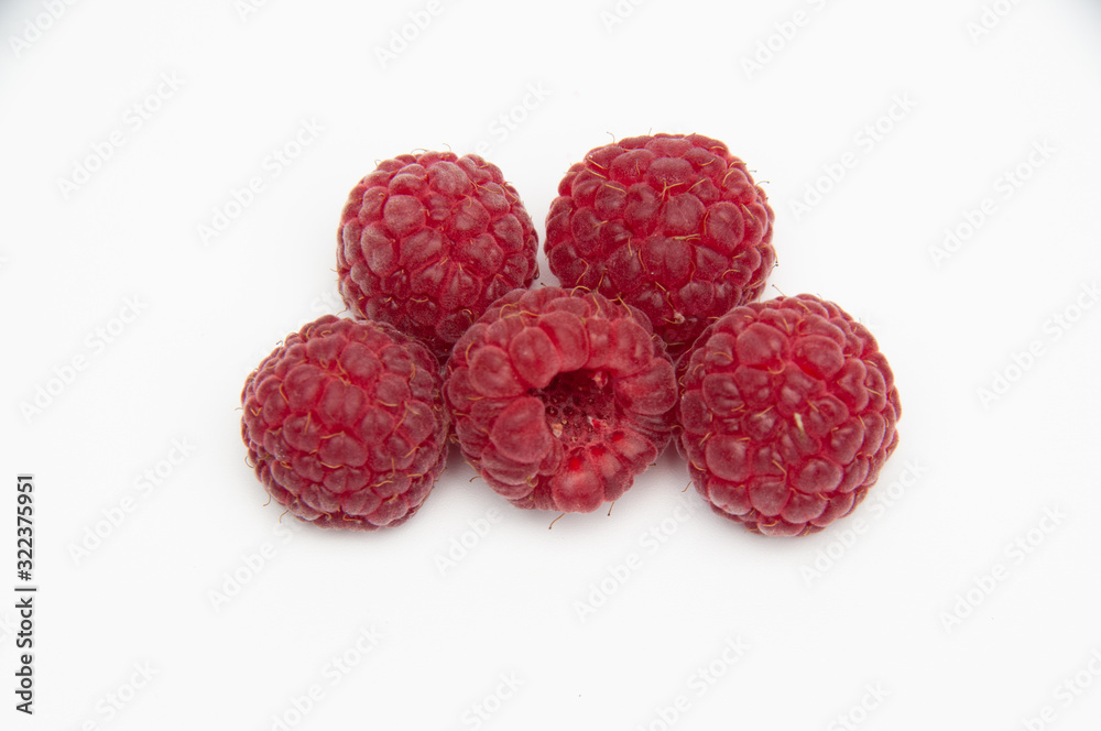 five red raspberries in the shape of a trapezoid on a white background five red raspberries in the shape of a trapezoid on a white background