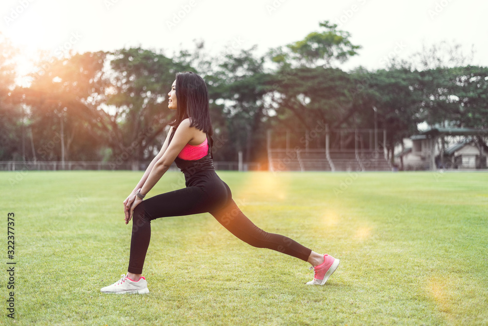 Women warm up before exercising outdoors during the morning hours in the park. Women warm up before exercising outdoors during the morning hours in the park.