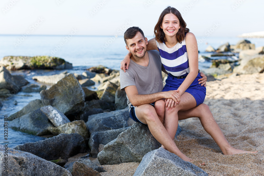 Young loving couple sitting and hugging