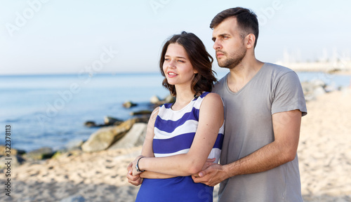 Happy loving couple standing and hugging