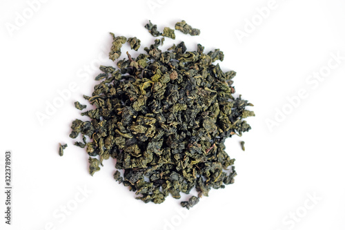 Oolong milk tea top view. Dry leaves of Chinese tea on a white background. Green tea for weight loss.