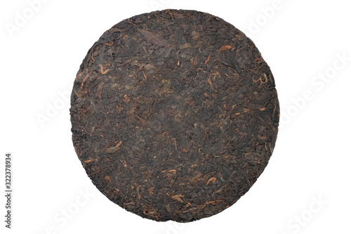 Pressed Chinese puer tea on a white background top view. Pressed pancake-shaped dry tea isolate.