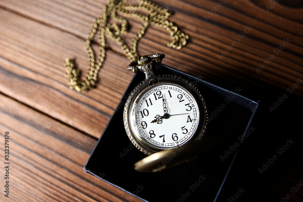 a pocket watch with book background