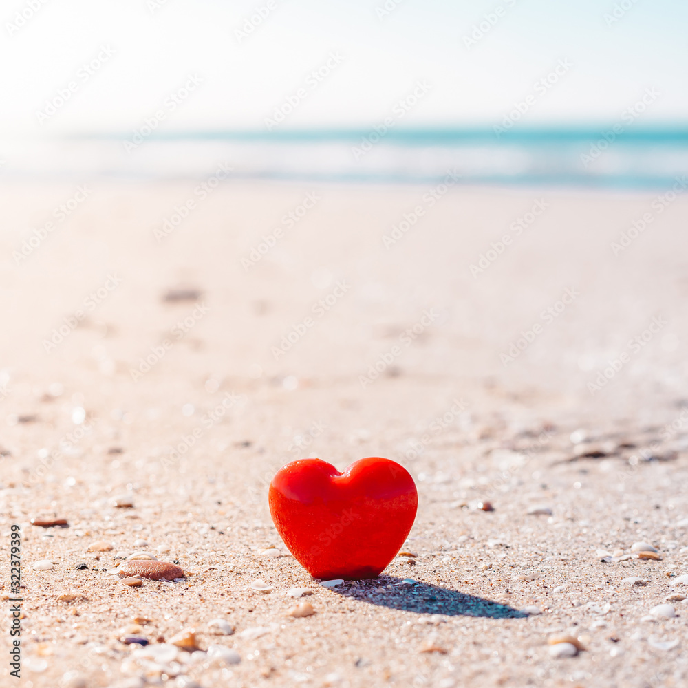 Romantic symbol of red heart on the sand beach Romantic symbol of red heart on the sand beach