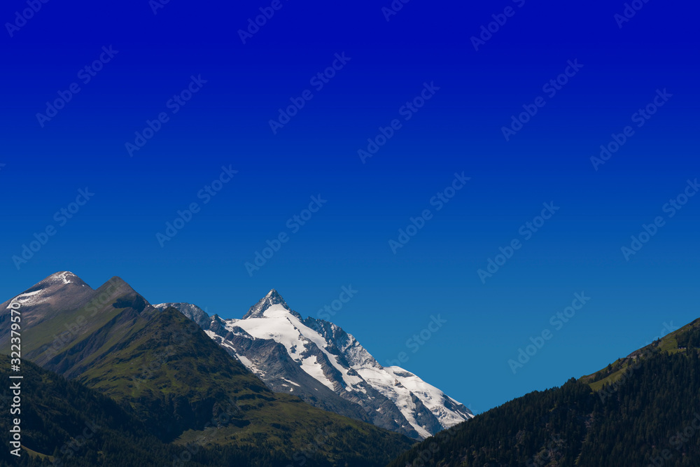 alpine peak of Grossglockner mountain in Austria. blue sky background for your text