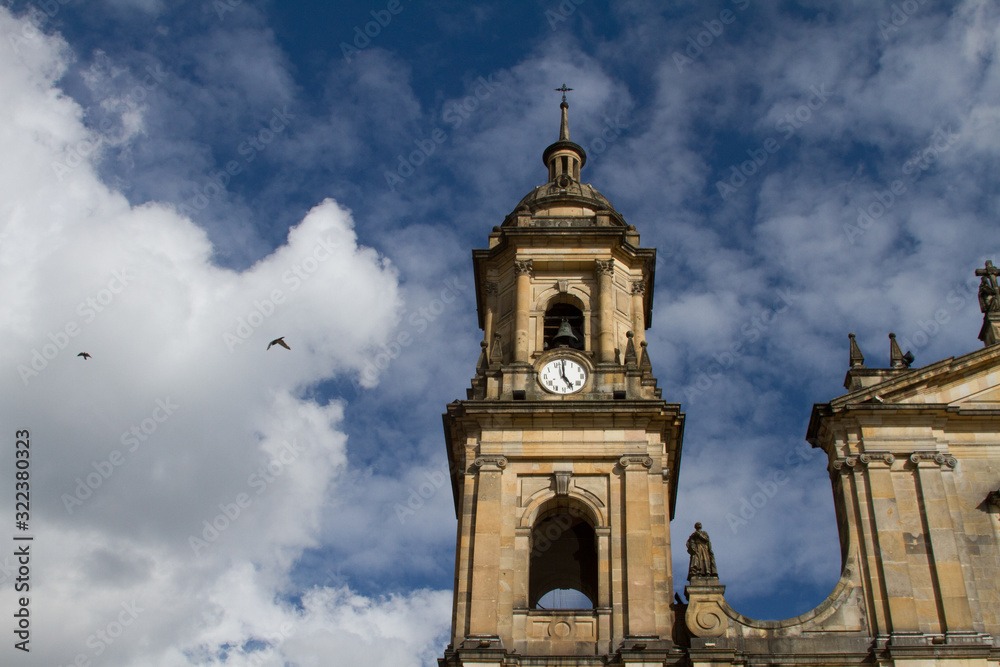 Church steeple against blue sky with clouds
