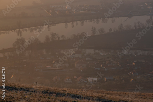 Sunrise time on Radobyl hill over valley of river Labe and Zalhostice village photo