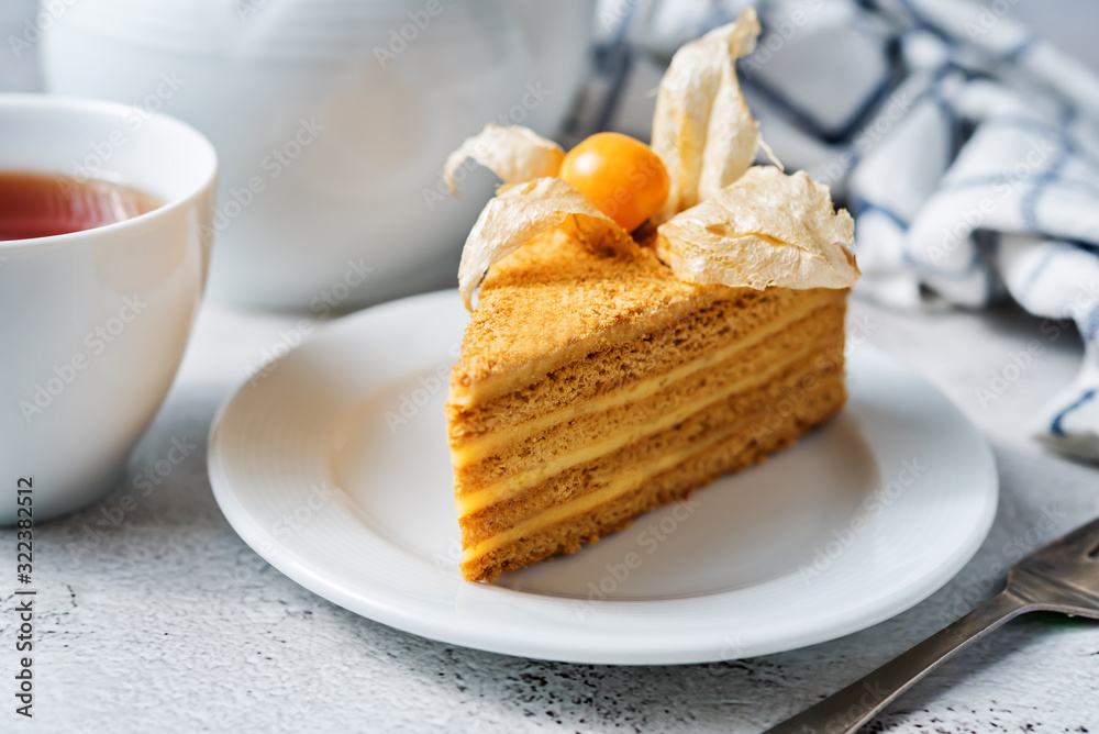 Honey cake with caramel cream filling decorated with physalis Honey cake with caramel cream filling decorated with physalis