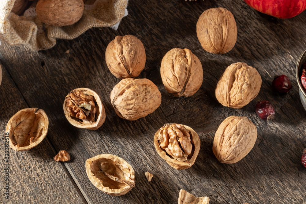 Whole and broken walnuts on a wooden table Whole and broken walnuts on a wooden table