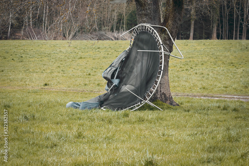 Vom Orkan beschädigtes Trampolin wird vom Baum aufgehalten photo