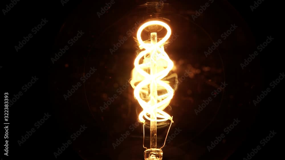 Slow rotation of Edison retro light bulb. Spinning vintage filament tungsten bulb revealing details idea view. Cozy nostalgic evening bedroom macro close up concept. 4k.