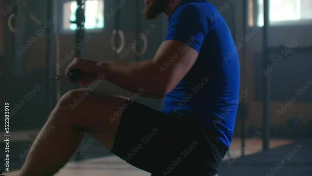 fitness man athlete training rowing machine exercise intense endurance workout challenge strong sportsman physical practice in gym healthy lifestyle motivation close up hands. slow motion fitness man athlete training rowing machine exercise intense endurance workout challenge strong sportsman physical practice in gym healthy lifestyle motivation close up hands. slow motion