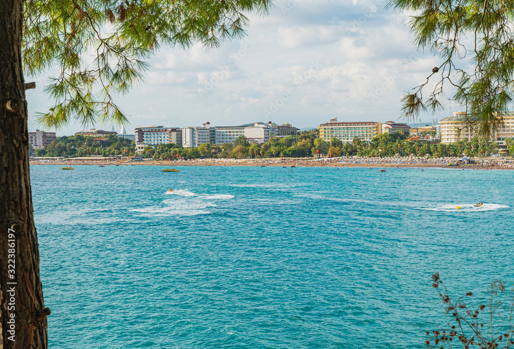 Turquoise mediterranean sea, Turkey. Defocused background with beach and hotels view. Color image and copy space.