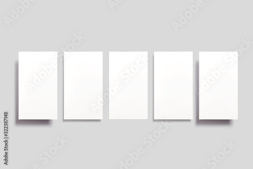Blank paper cards soaring in the air isolated on grey. Can be used for social media stories  promotions  screens etc.