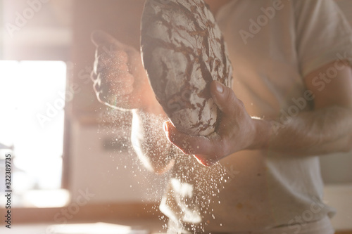 Bäcker presentiert bio Brot in der Backstube photo