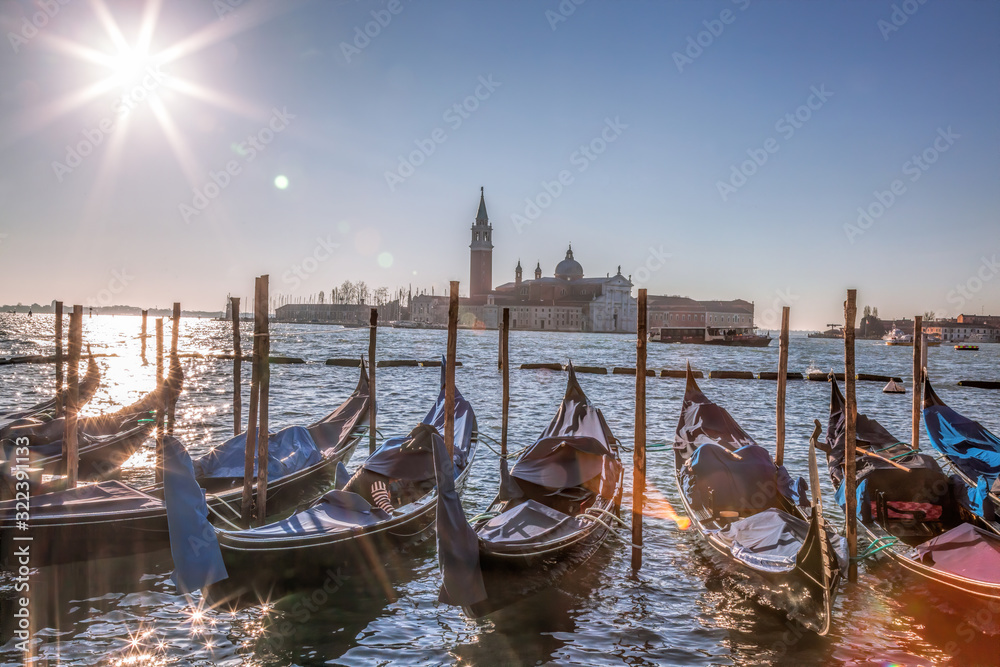 San Giorgio Maggiore Church with venetian gondolas at the harbor in Venice. Italy