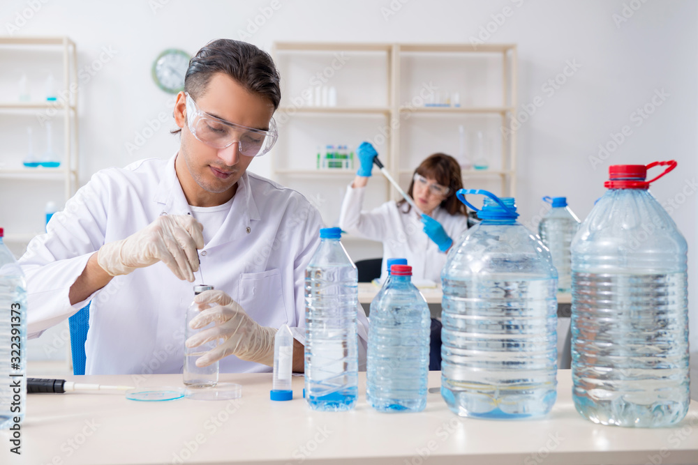 Two chemists working in the lab Two chemists working in the lab