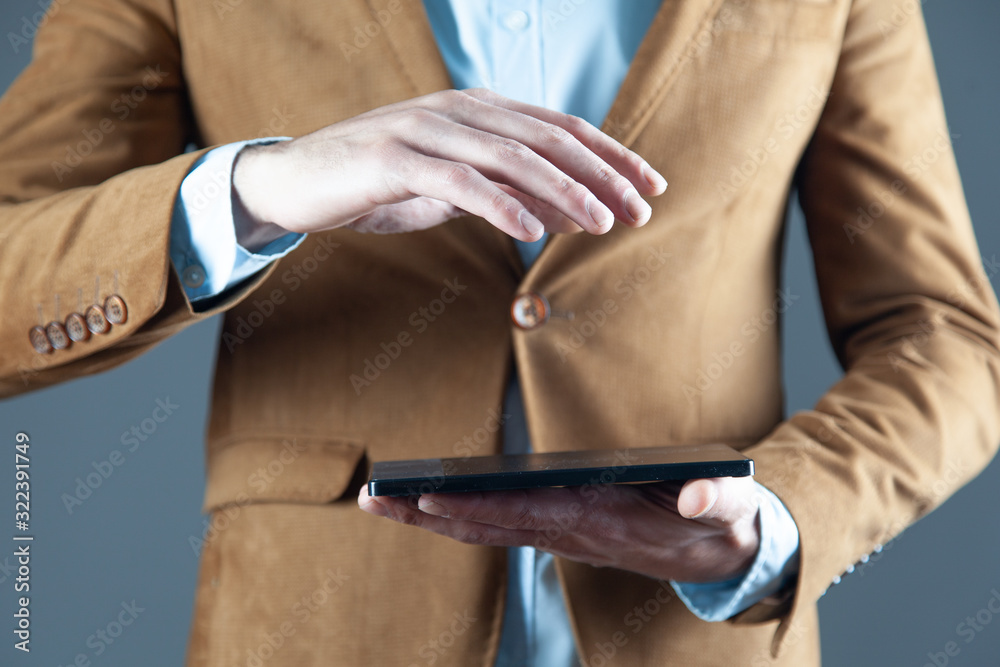 man hand holding tablet on grey background man hand holding tablet on grey background