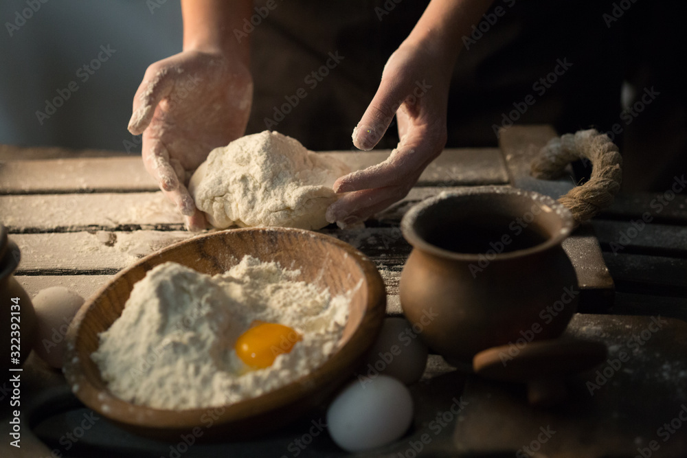 Fototapeta premium Making dough by female hands at home